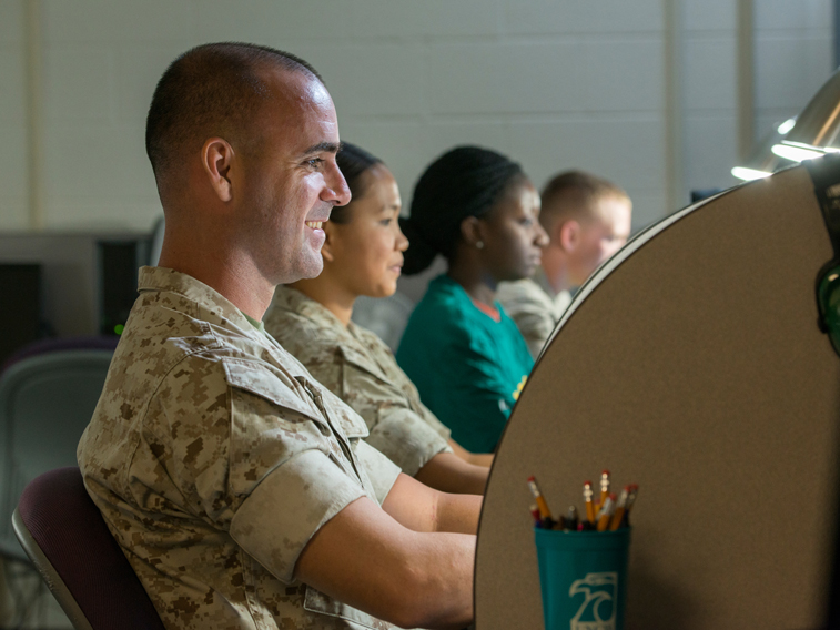 Enlisted man sitting at computer