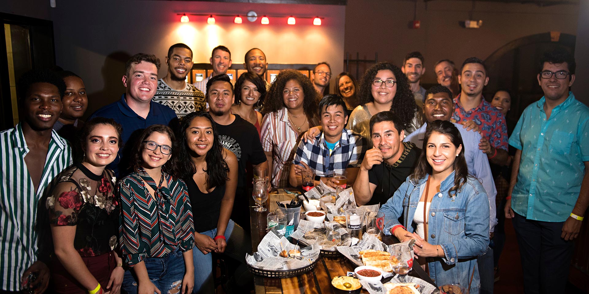 A group of people smile for the camera during a Hispanic Heritage month party