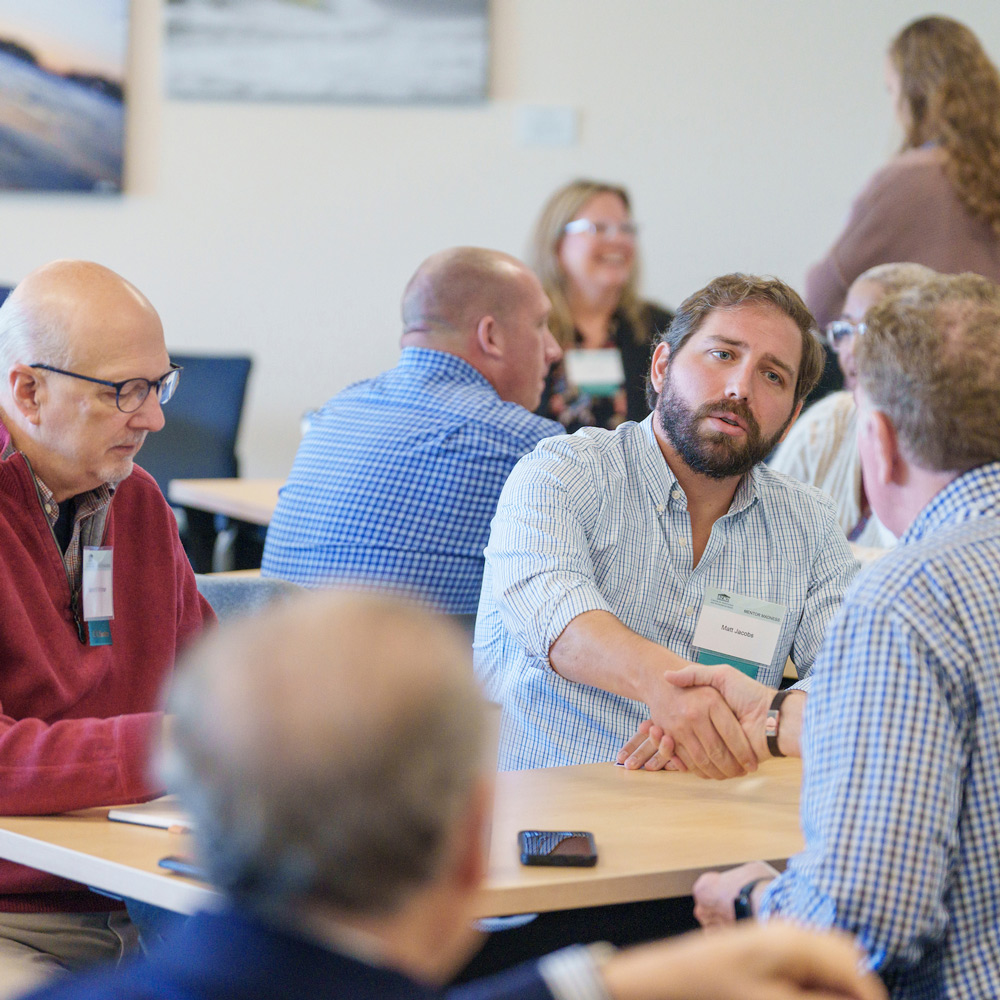 People meeting and shaking hands around a table