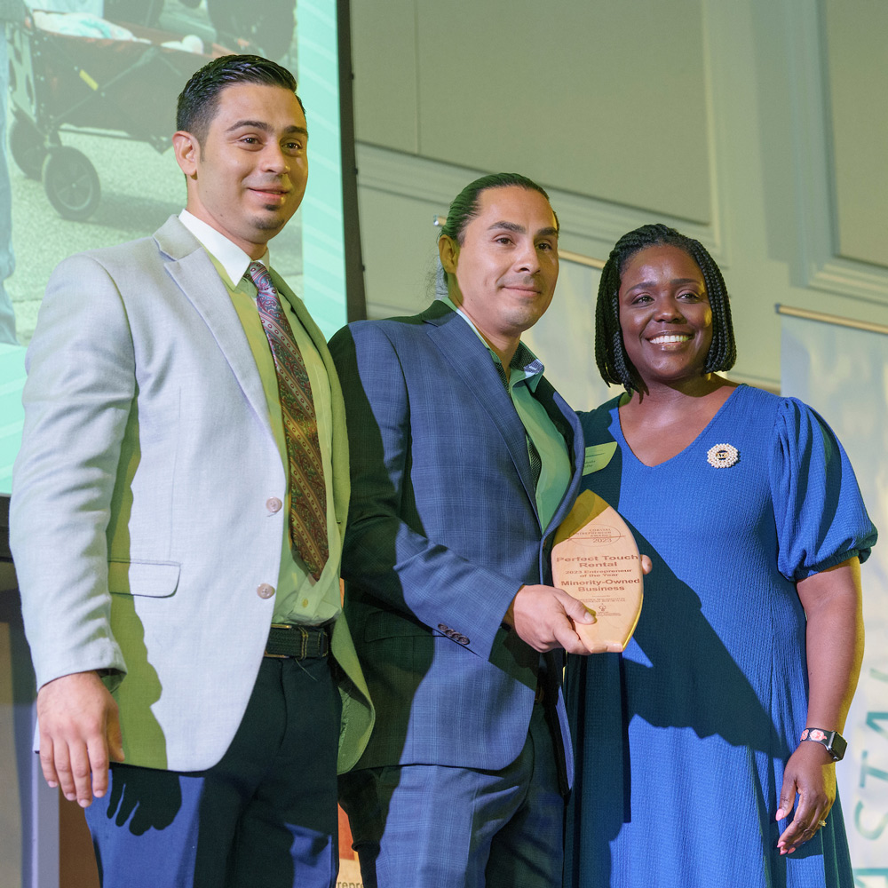People on stage accepting an award.