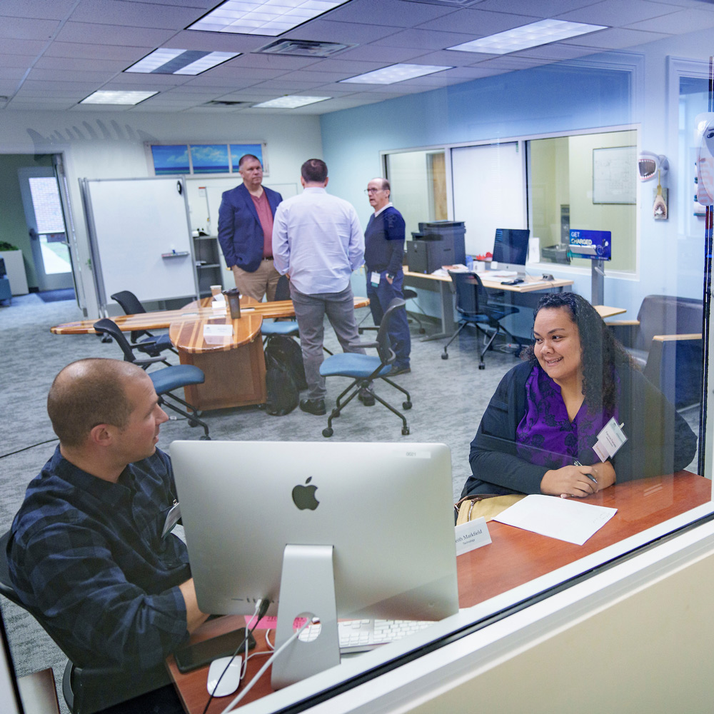 People having conversations in an office setting