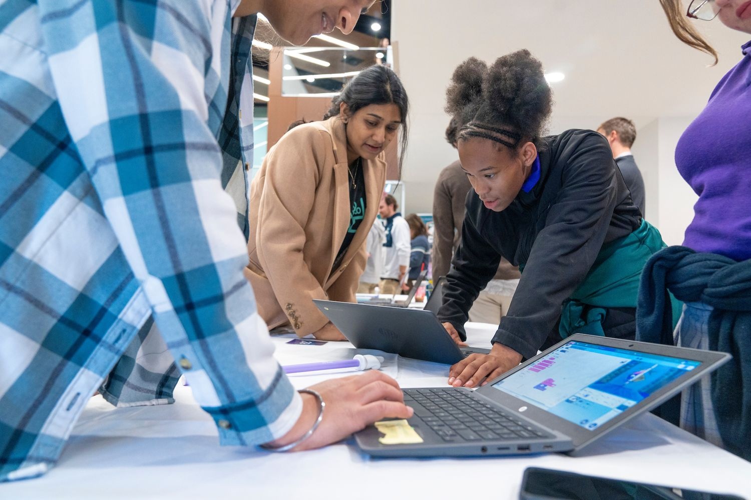 Professor helping student study on laptop