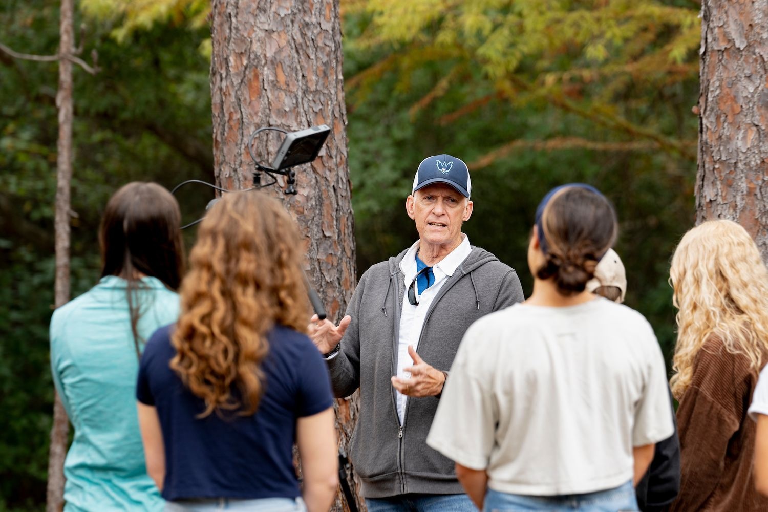 UNCW Associate Professor Bill Bolduc of Communication Studies department works with his students in COM380 on outside lighting techniques for video production.