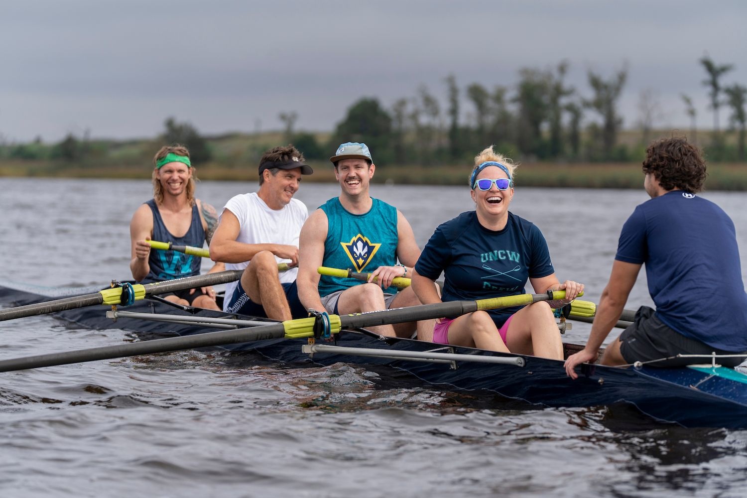 The UNCW Rowing Club gathered with alumni and launched its boats at Belville Riverwalk Park in Brunswick County.