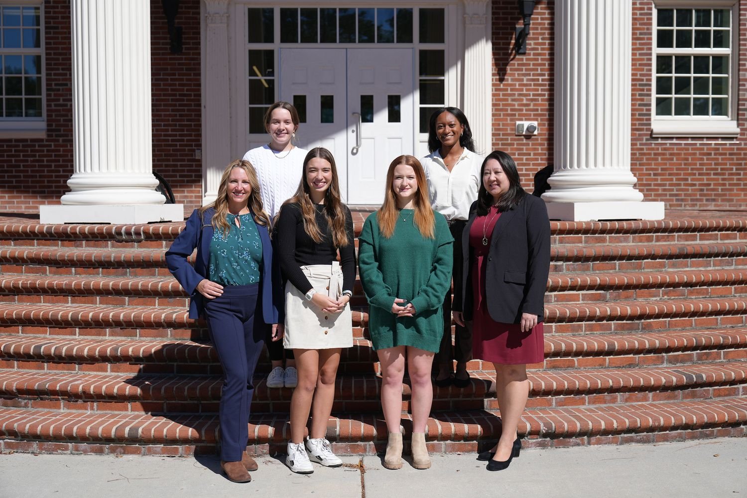 People standing in front of the steps of a building