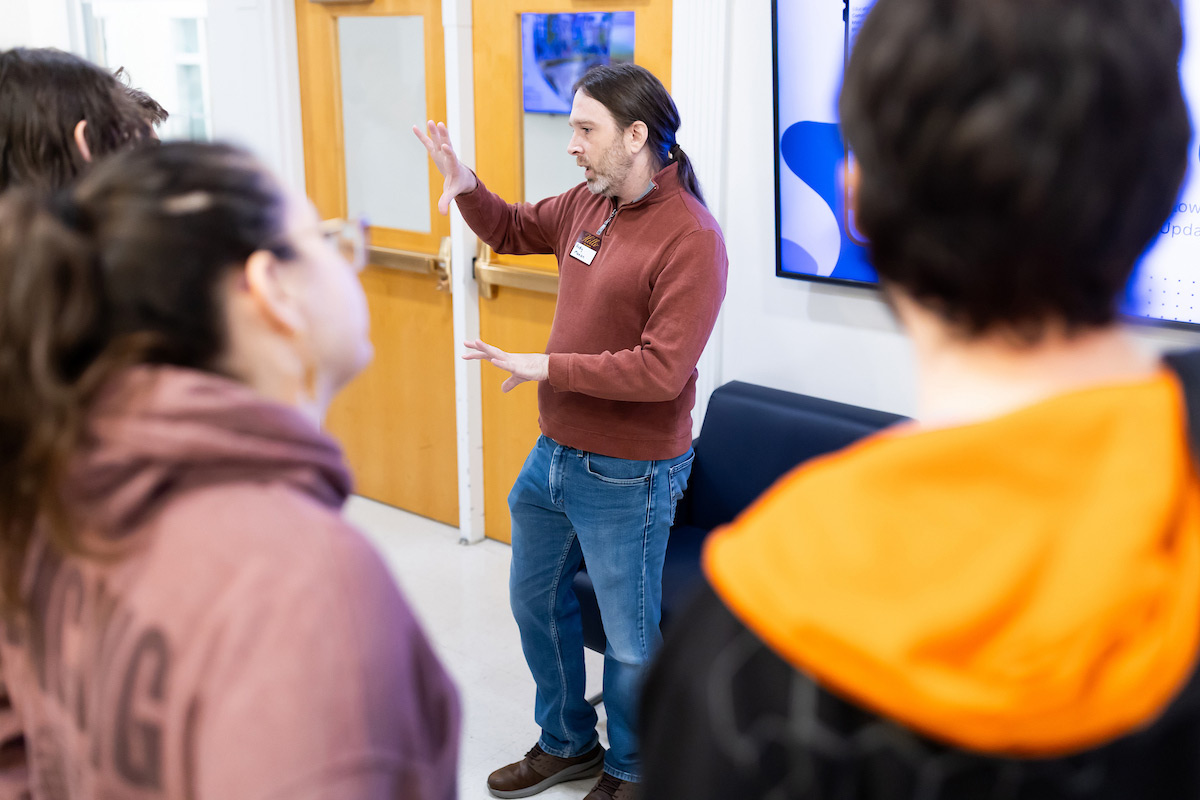 A presenter talks to students about math