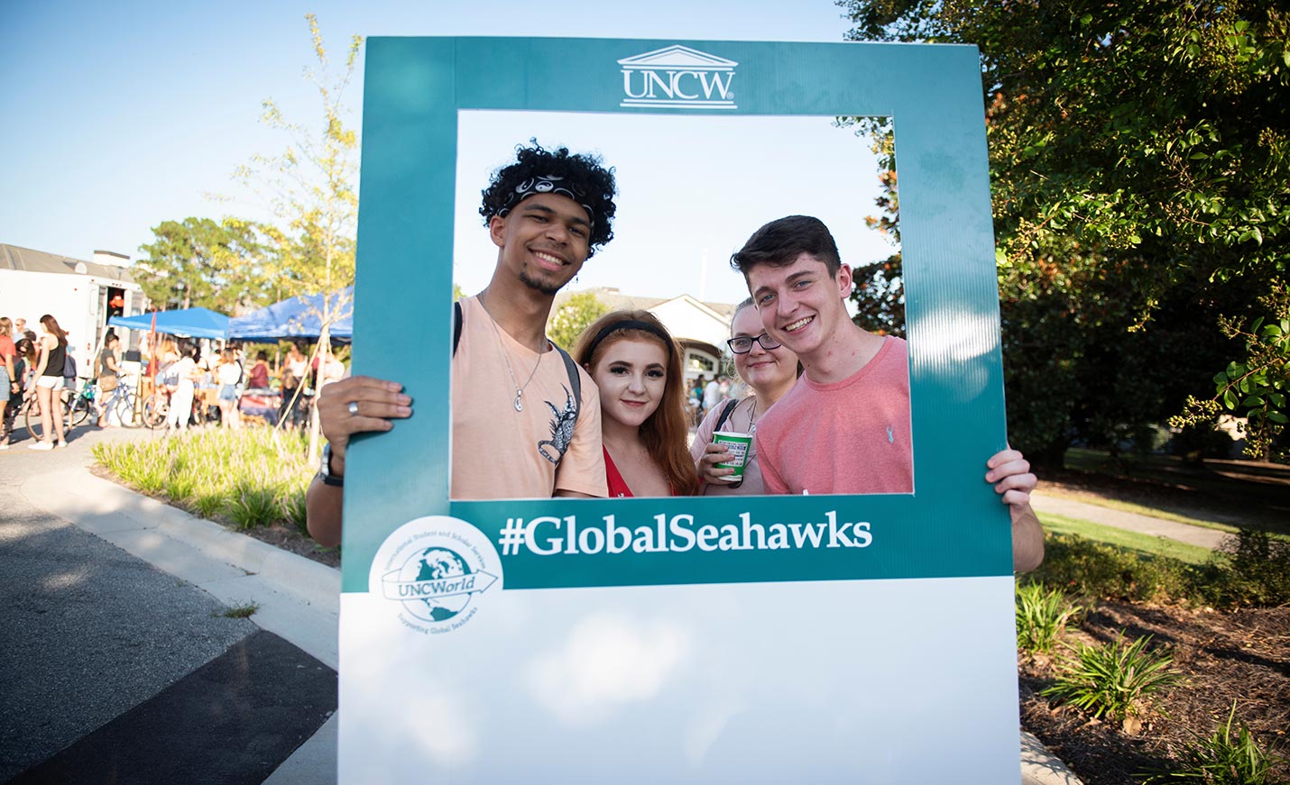 Students standing in a #GlobalSeahawks frame