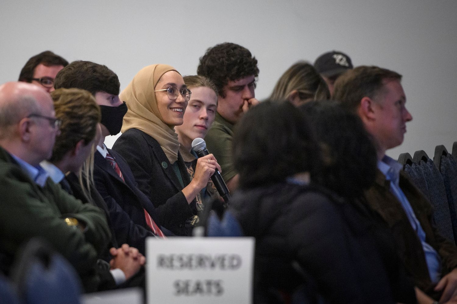 An attendee at the 22st annual Sherman Lecture at UNCW speaks into a microphone