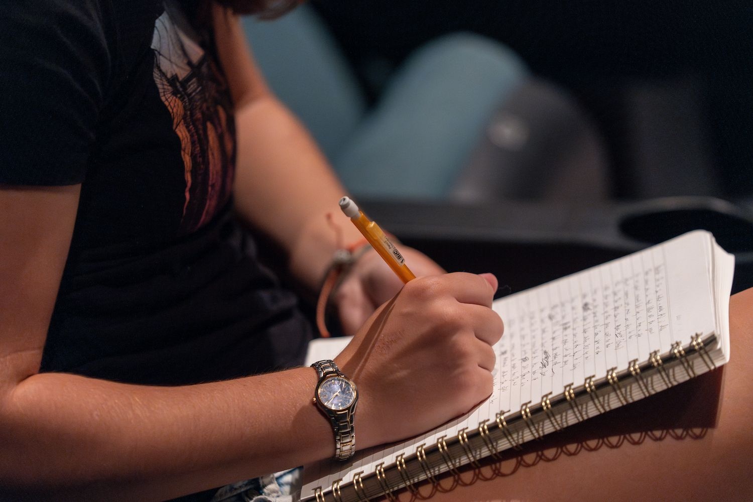 A student writes in a notebook during UNCW's 2024 Writers' Week