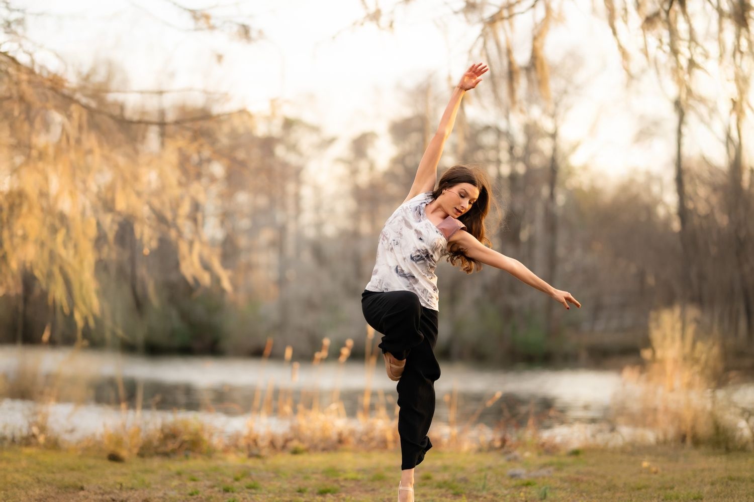 Student dancing near a lake.