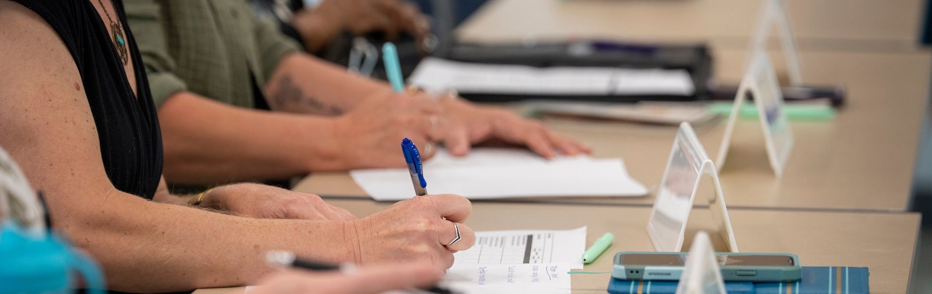 3 students take notes