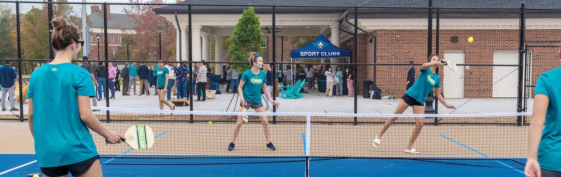 Patrons playing pickleball at the courts located on campus