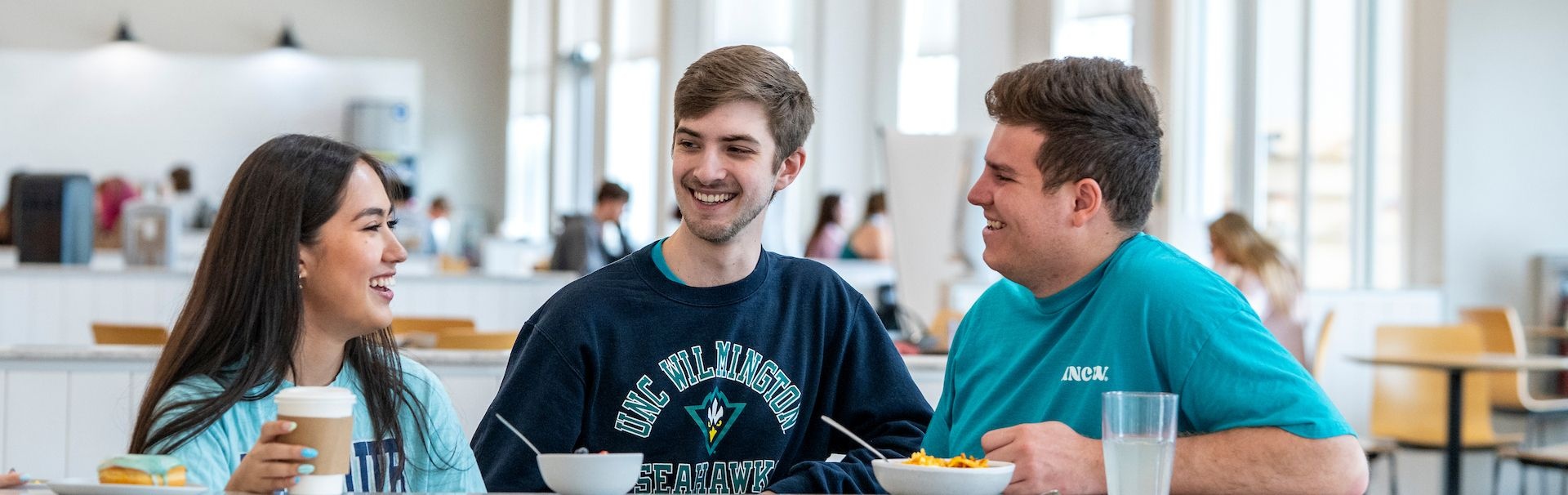 groups of students sitting at a table eating at the Shore Dining hall