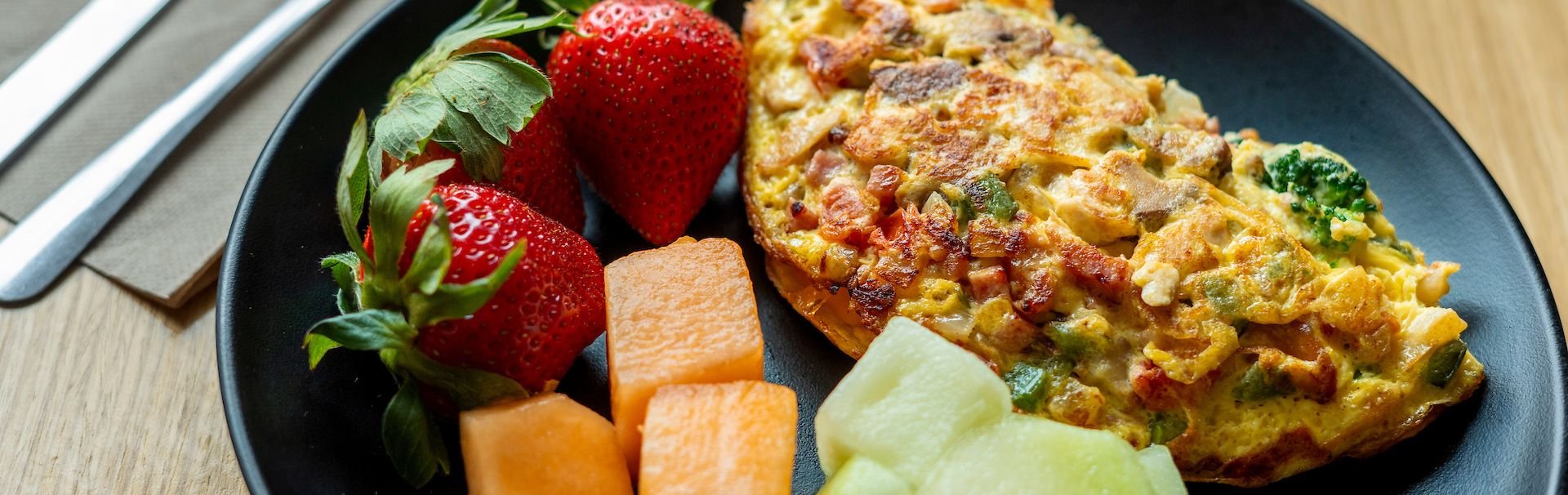 Fresh fruit and omelette served at a dining hall