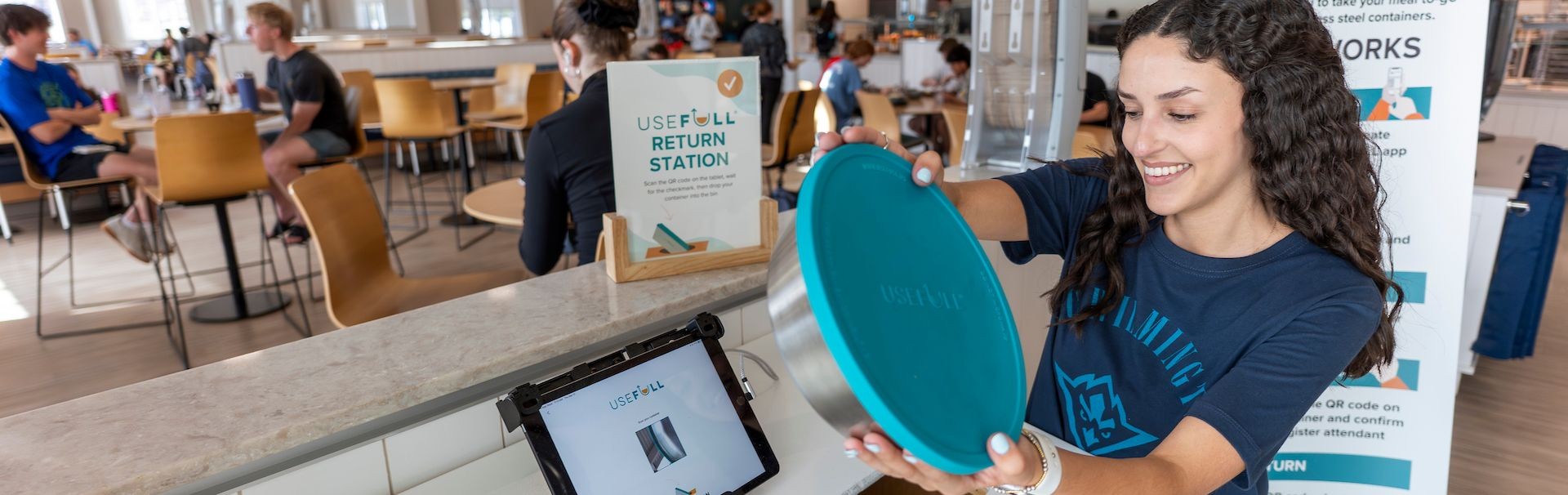 Student checking out a Useful to-go container at the shore dining hall 