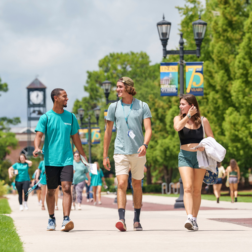 Students walk beneath banners on Chancellors
