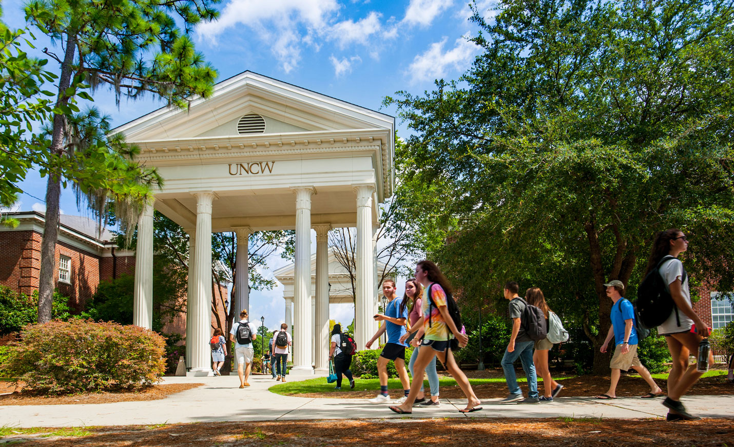 students walking on campus in front of columns