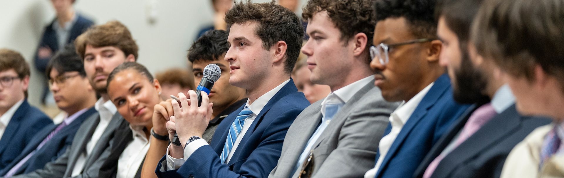 student speaking during business week session