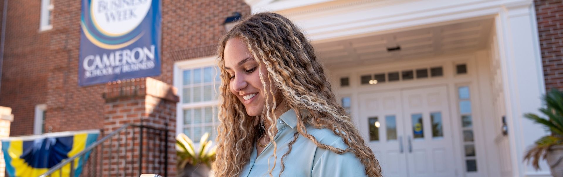student outside of cameron hall
