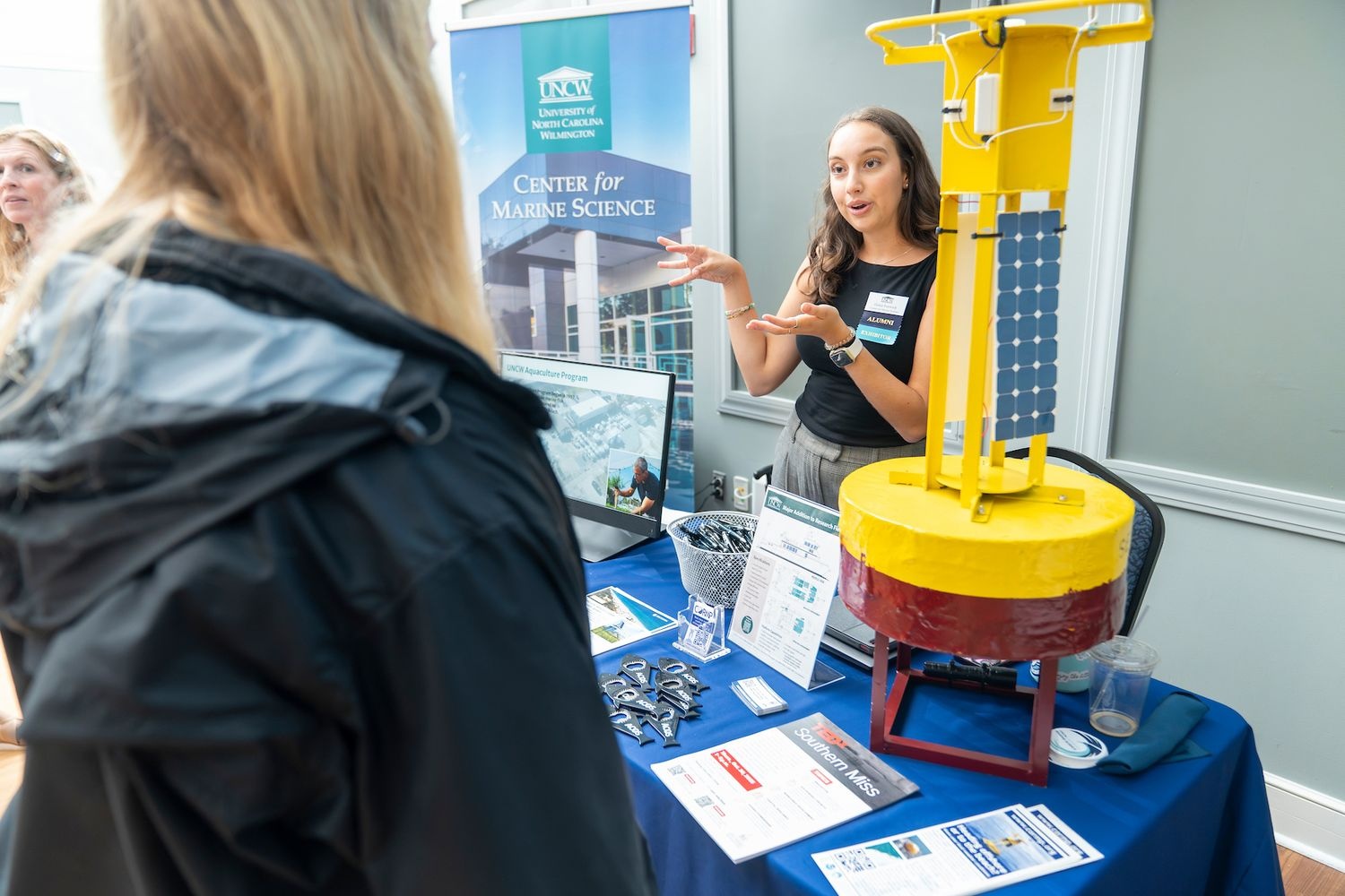 A presenter at a booth at the Ocean Innovation Conference