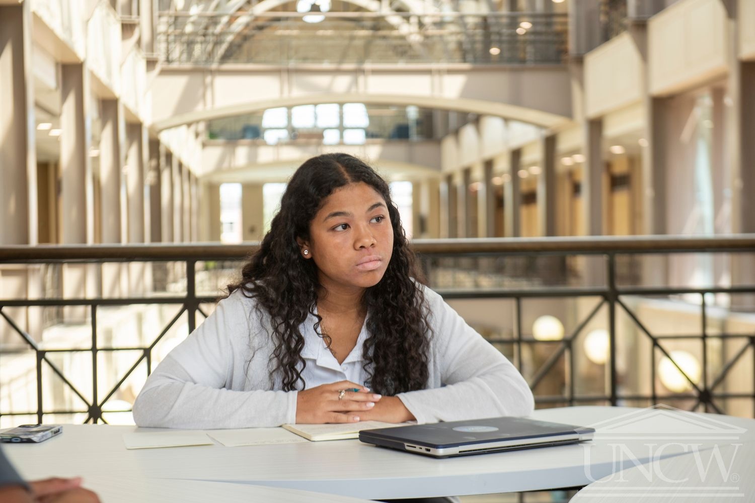 Advise NC adviser seated at a table with a notebook and laptop.