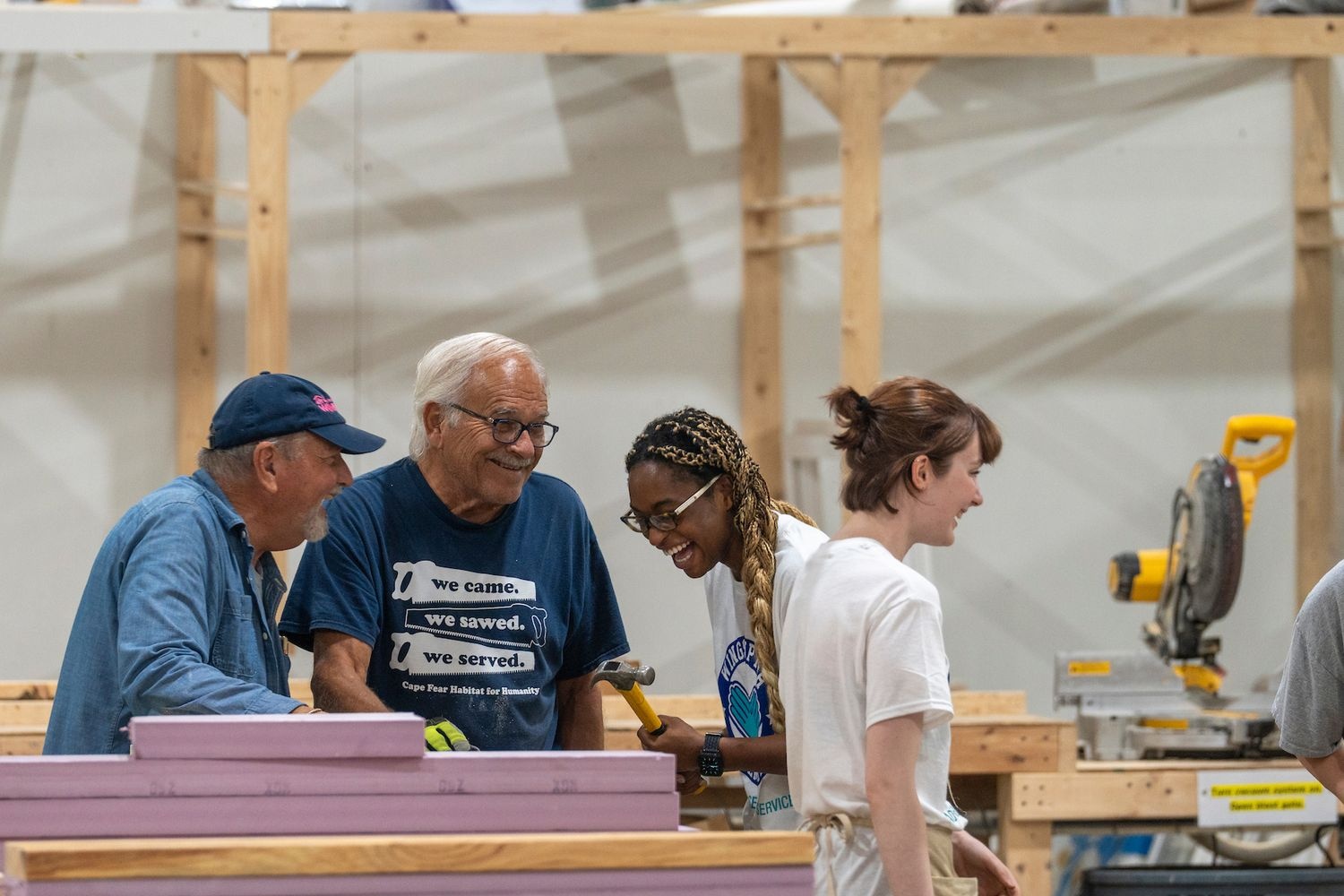 Wings Up Wilmington participants, 2024, in a warehouse with construction tools