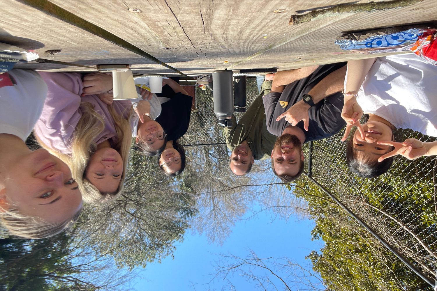 Students sitting at a picnic table outside