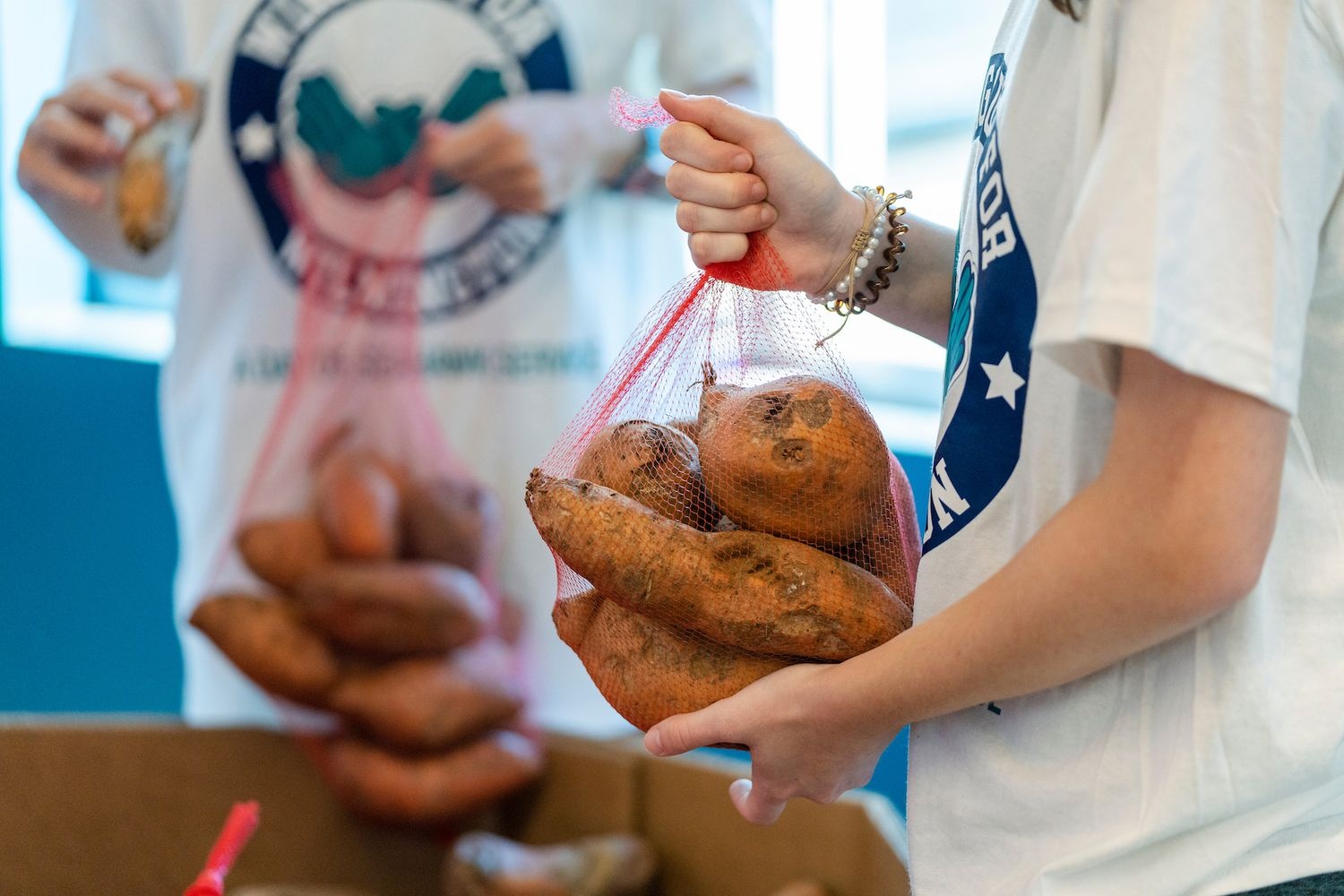 Holding bags of potatoes