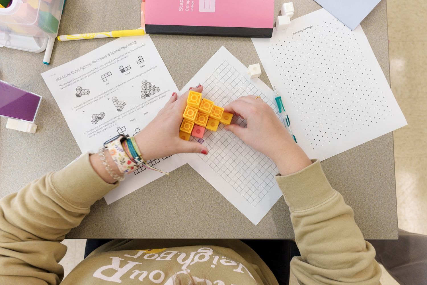 Hands arranging geometry cubes
