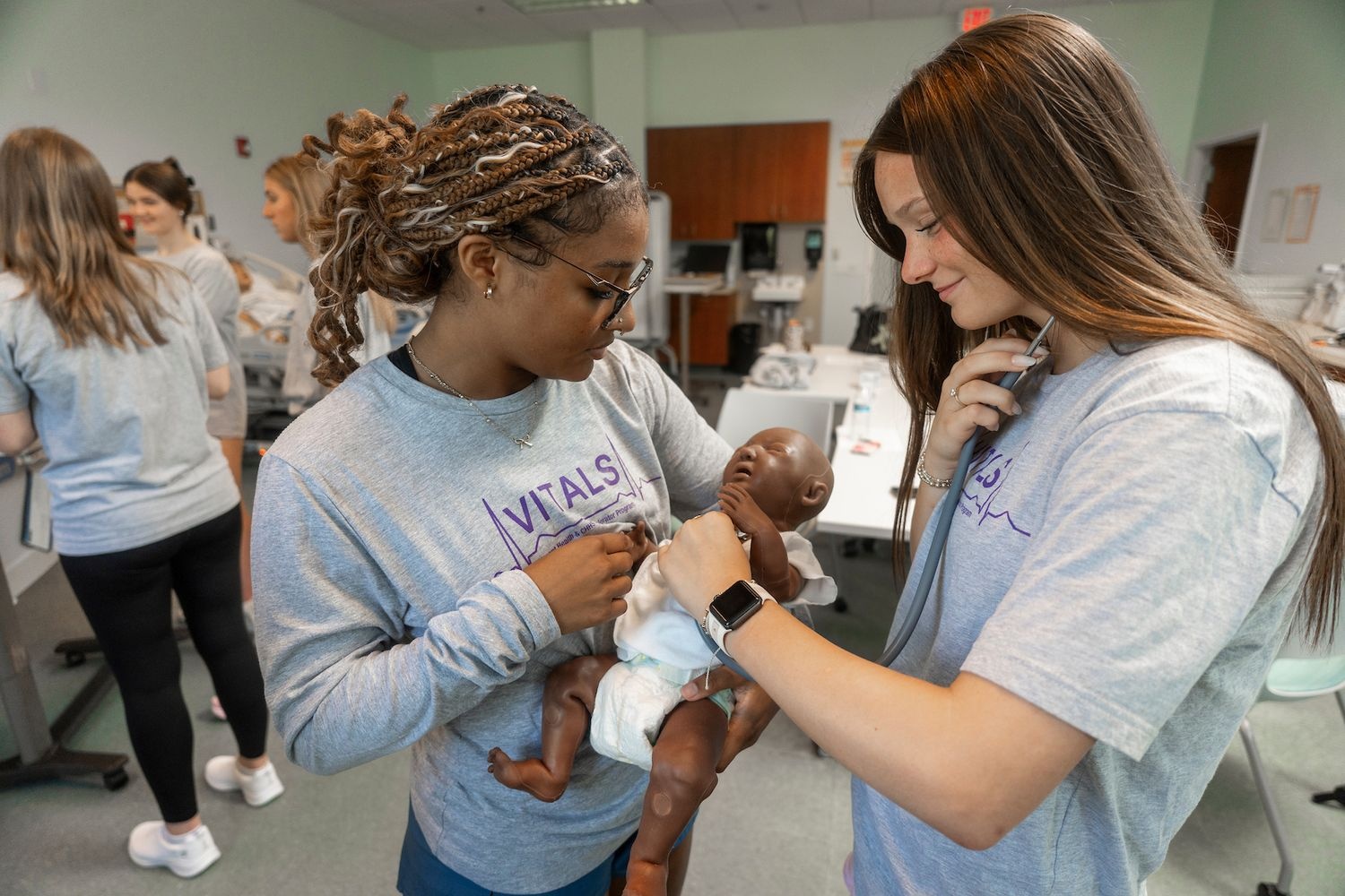 Student group practicing taking vitals