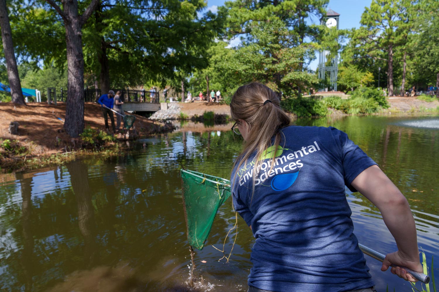 Cleaning up a pond in a boat
