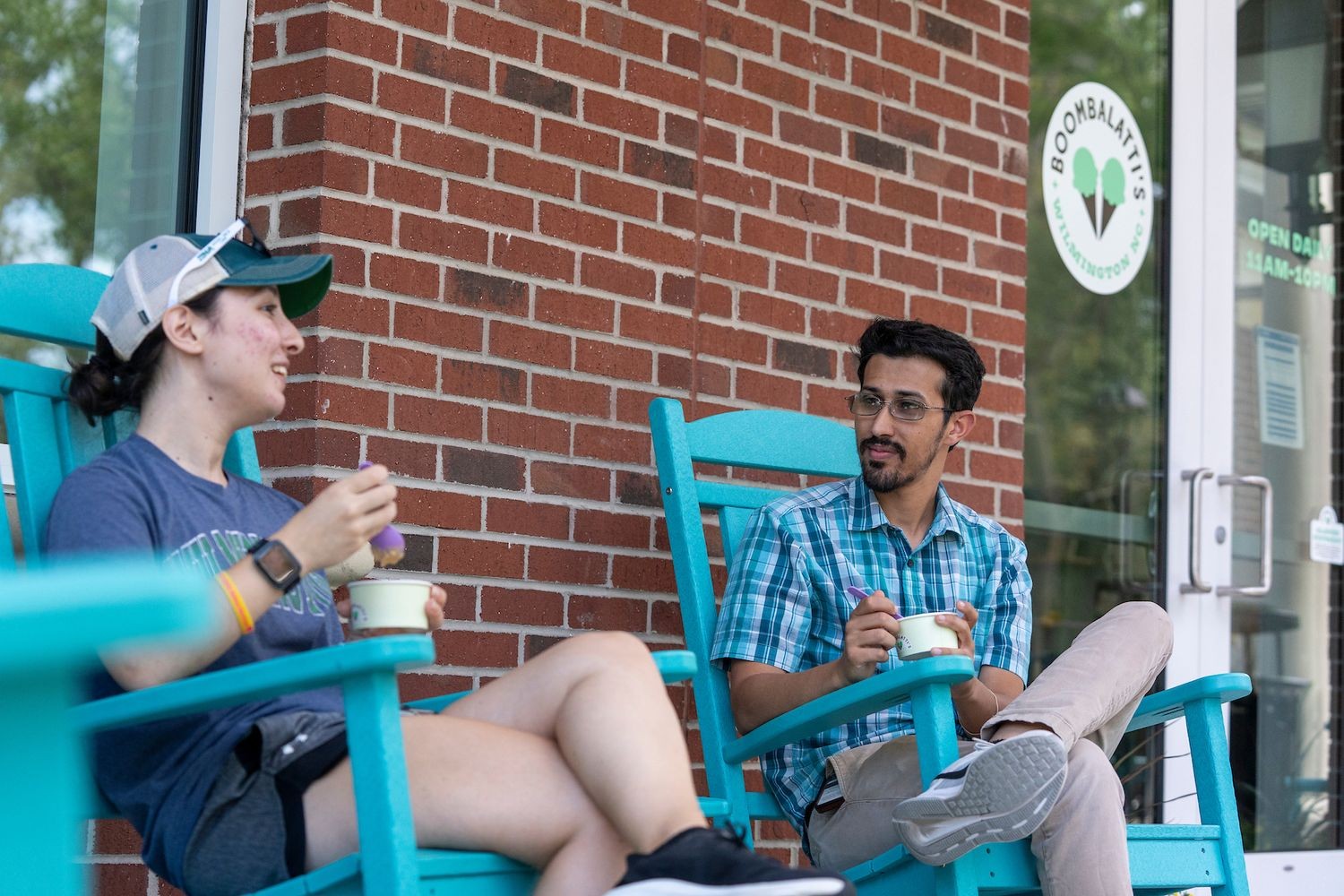 Students enjoying ice cream in Adirondack chairs