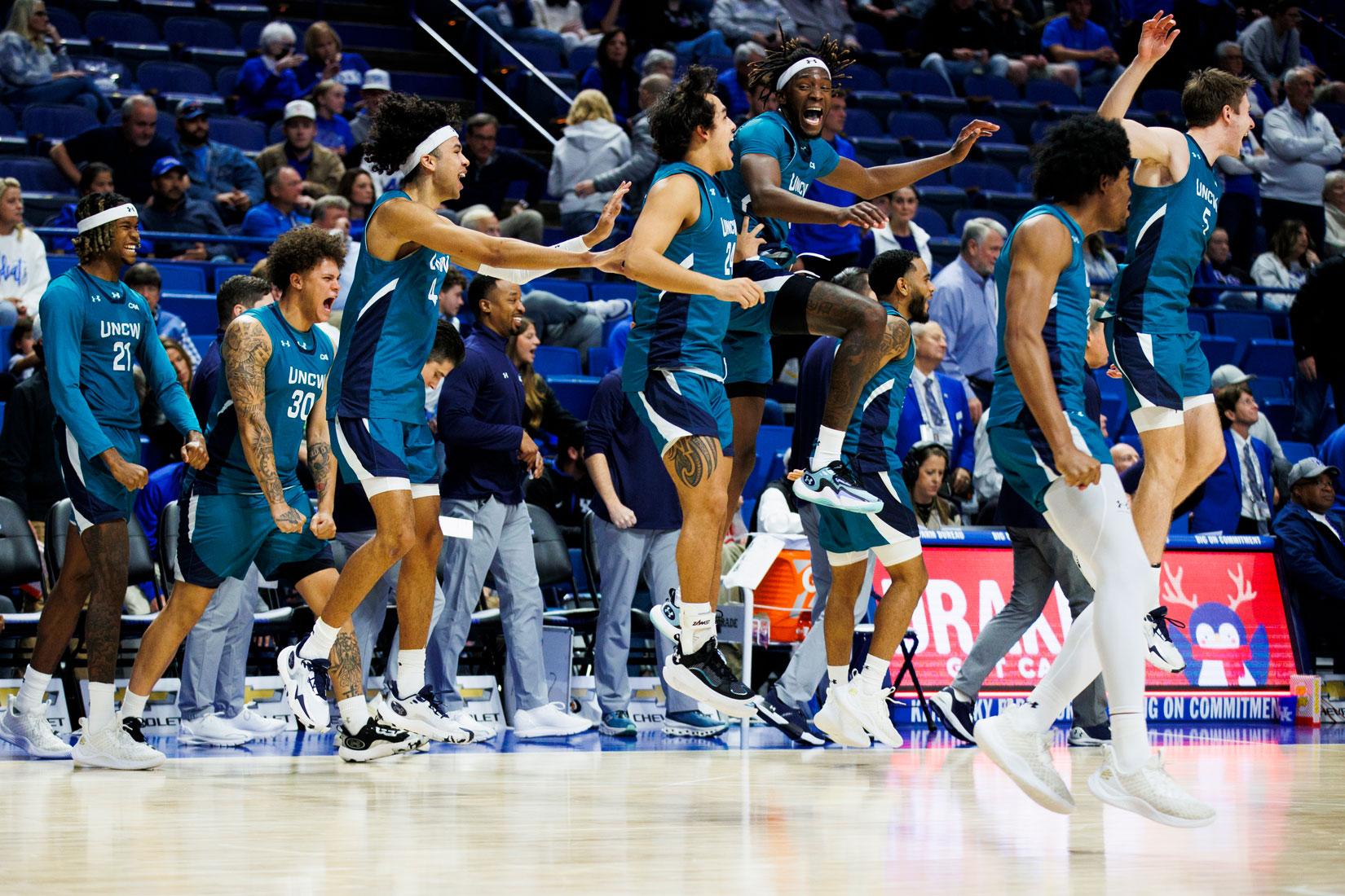 UNCW Men's Basketball Team celebrate after win over the Kentucky Wildcats on Dec. 2.