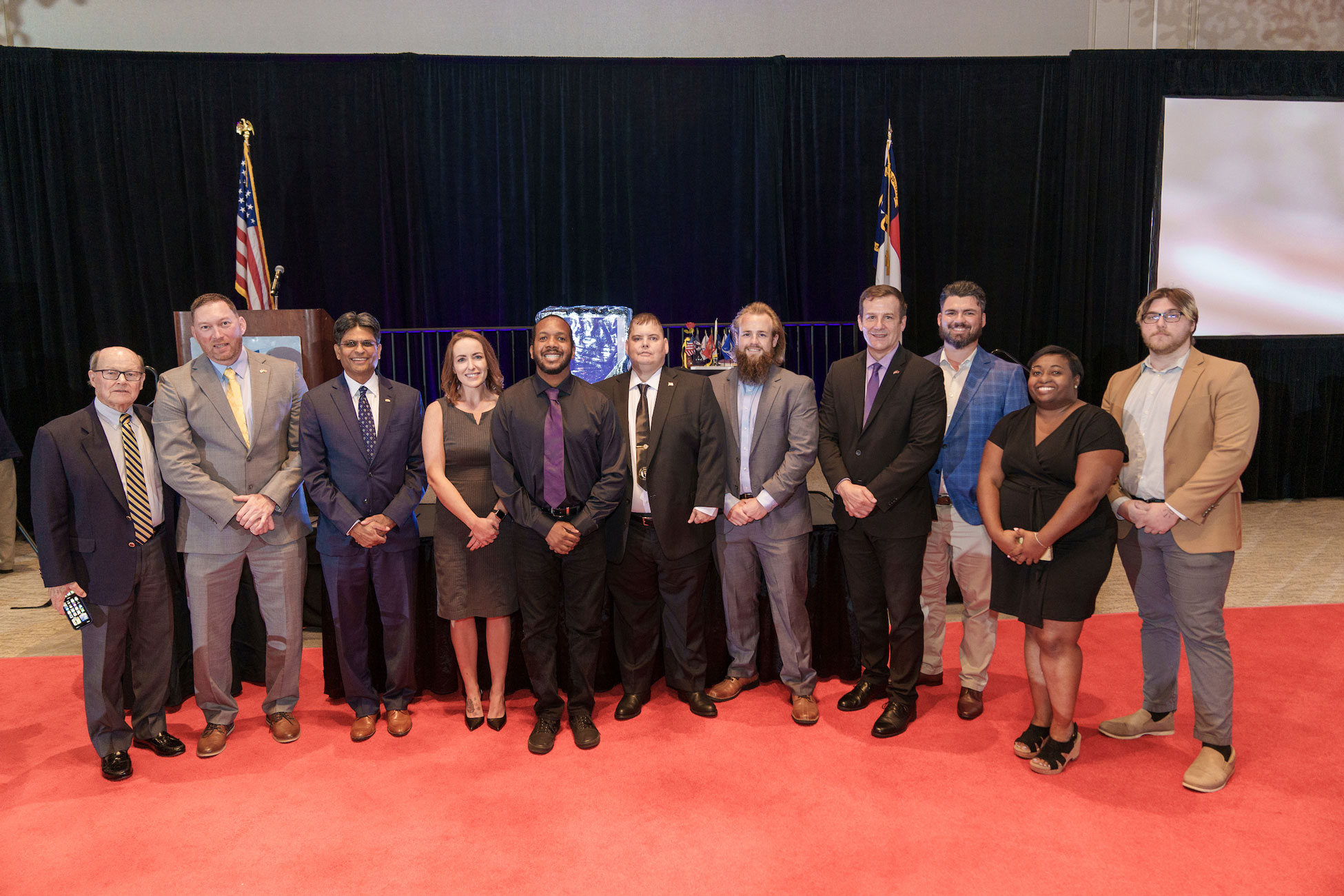 Members of the UNCW Student Veterans Organization celebrate with alumni and dignitaries at the Cape Fear Purple Heart Dinner on Aug. 5, 2023. Left to Right: Allen Patrick, co-director of the Cameron Executive Network, Silver Star and Purple Heart recipient; Will Messick, alum; Chancellor Aswani K. Volety; Leanne Churchill, alum and former SVO President; Deon Wrenn, student; Dusty Sanders, SVO vice president; Dakota Lowery, student; Bill Kawczynski, Director Military Affairs; Camden Ege, program coordinator, Office of Military Affairs; Natalie Lewis, SVO President; Devon Chambers, alum.