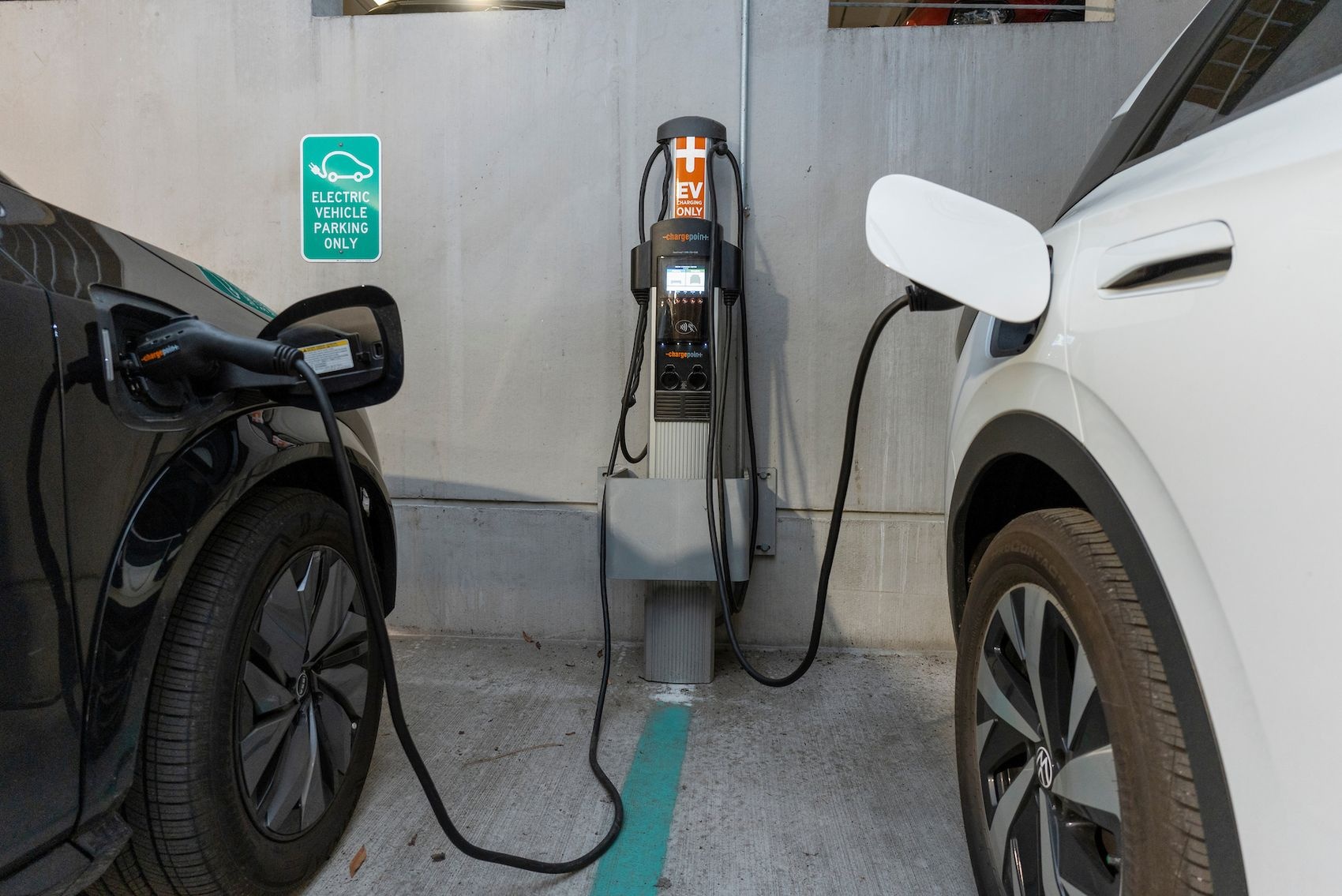 Electric vehicles charging at a campus station.