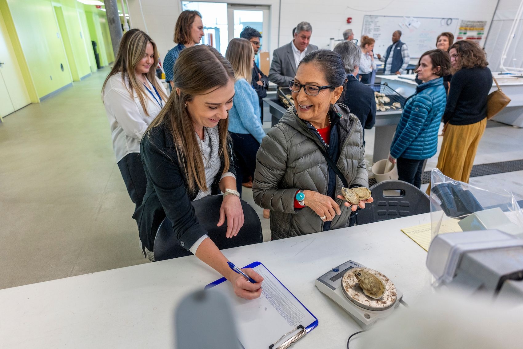 Visitor interacting with staff and students.