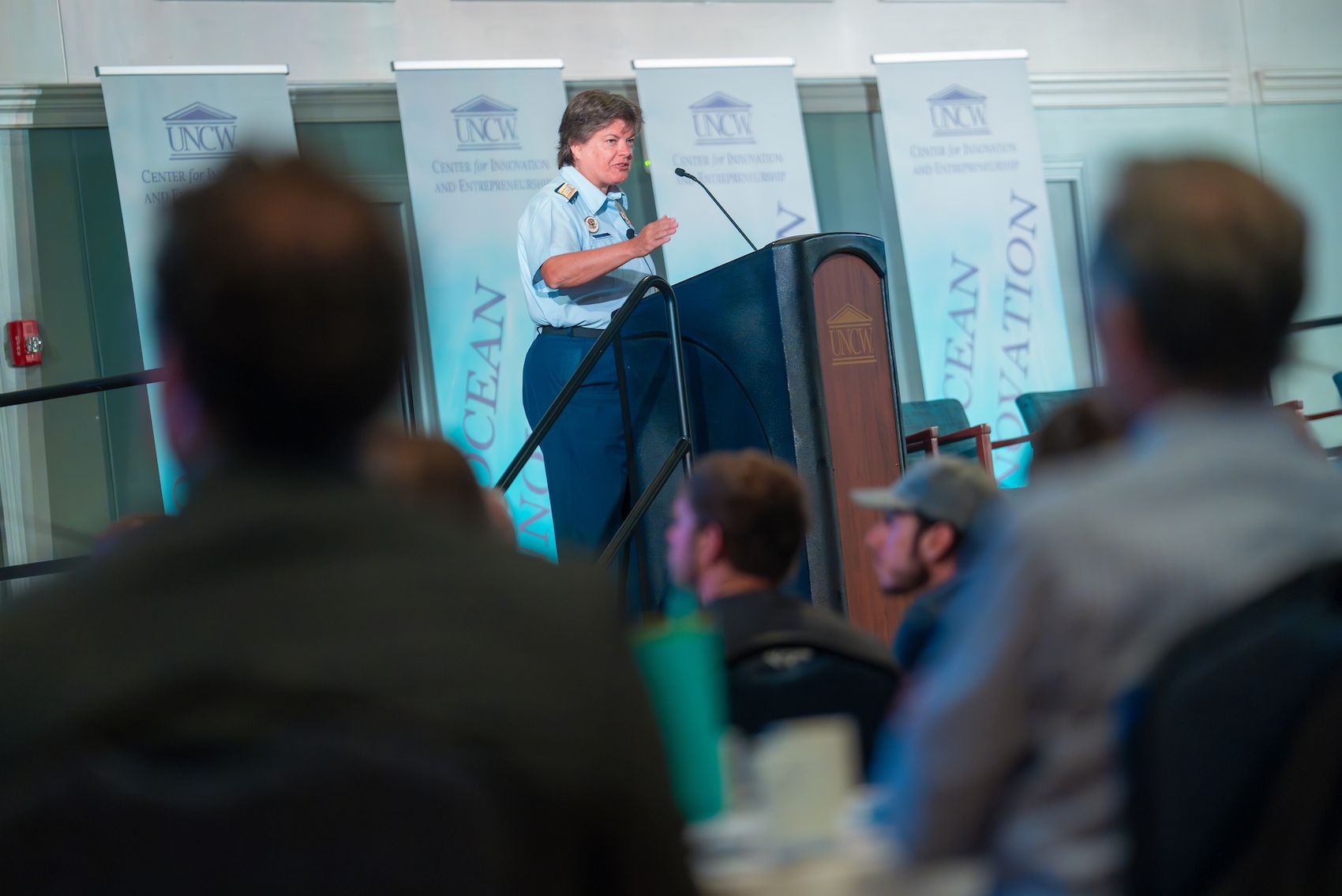Person addressing a crowd from a podium