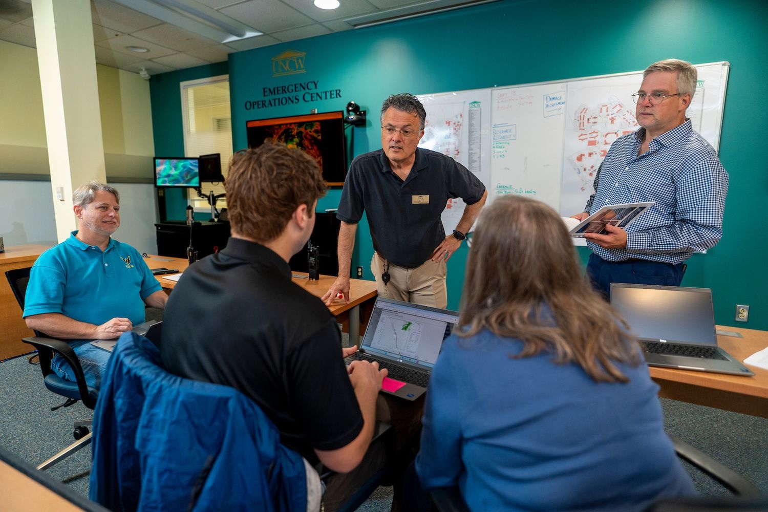 UNCW Emergency Management staff gather in the university's emergency management center 