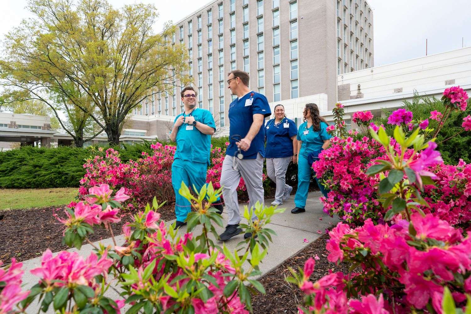 Cape Fear Community College nursing students (navy blue) Matthew Stinson and Kaopua Sutton and UNCW School of Nursing students (teal) Cloie Osorio and Kris Mosher-Gomez finish up their clinicals at Novant Health New Hanover Regional Medical Center. 