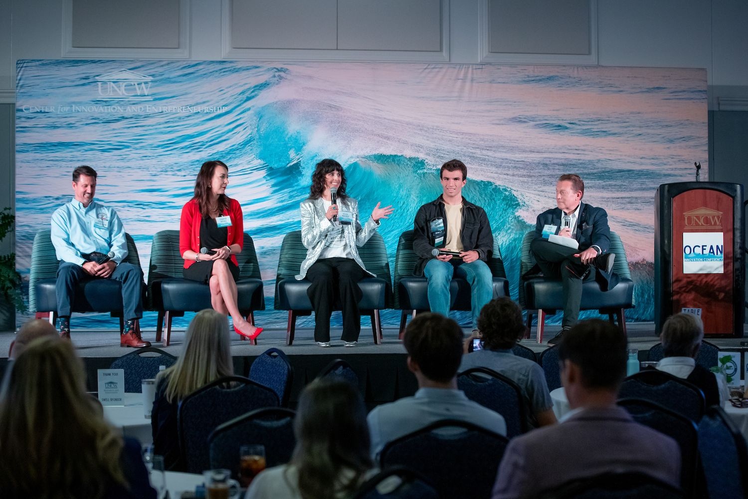 Five panelists sitting on stage mid-conversation at the 2025 Ocean Innovation Conference.