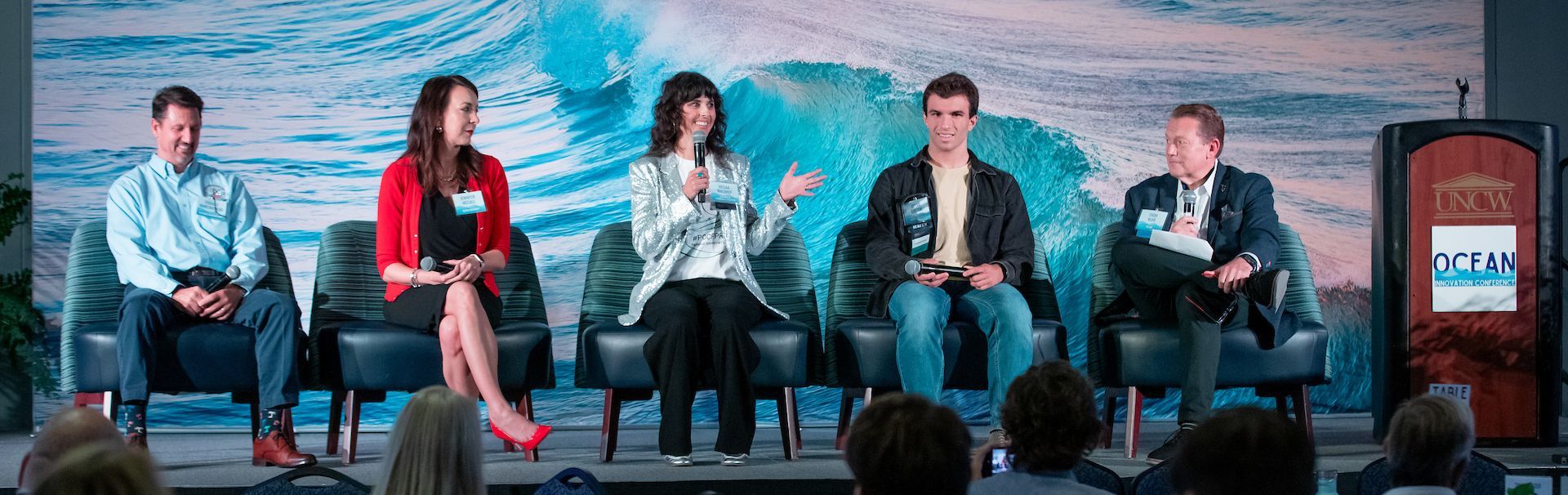 Five panelists sitting on stage mid-conversation at the 2025 Ocean Innovation Conference.