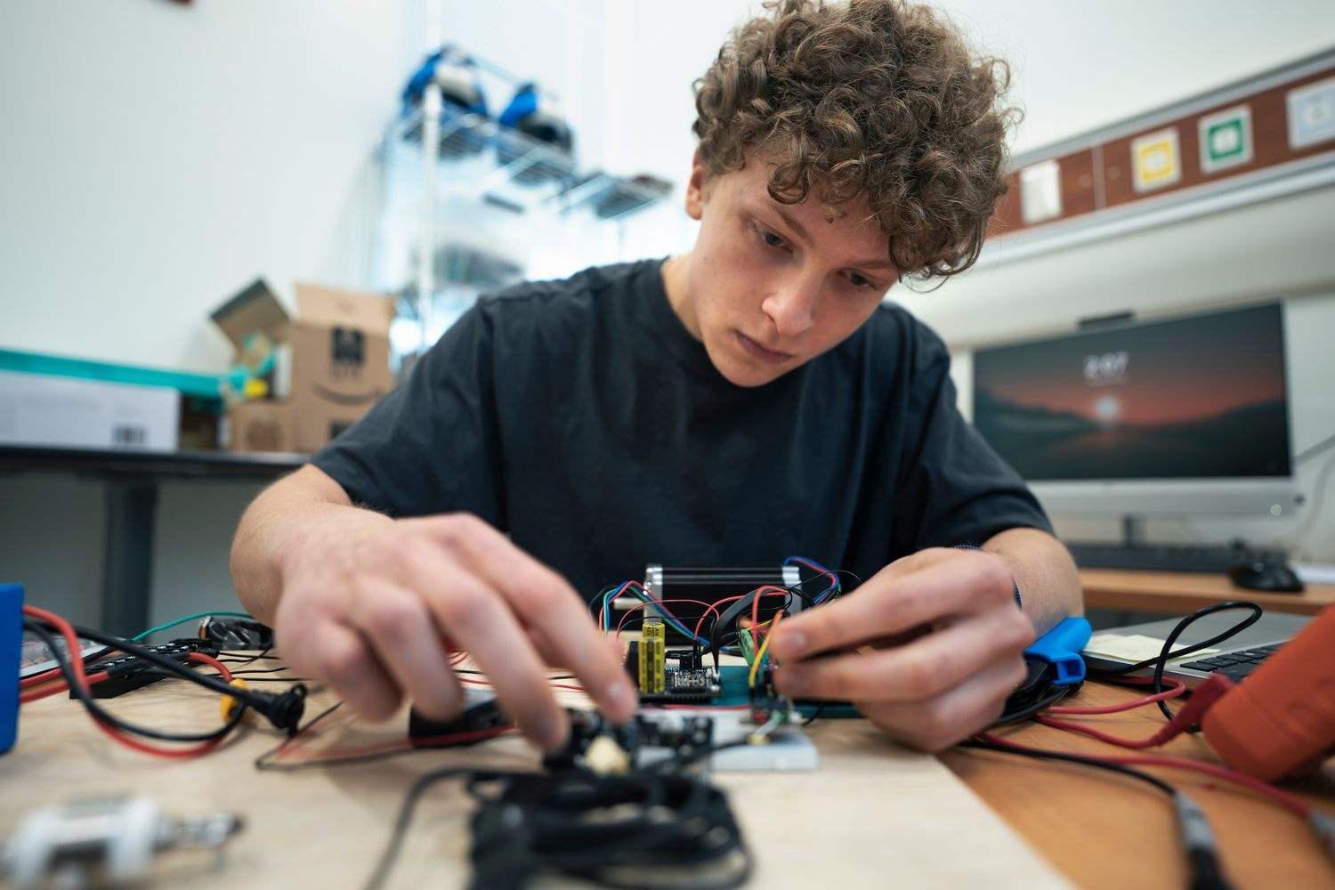 Holden Krueger a sophomore in Computer Science, puts together hardware as part of his job for UNCW’s Brain Health Resilience Research Hub.