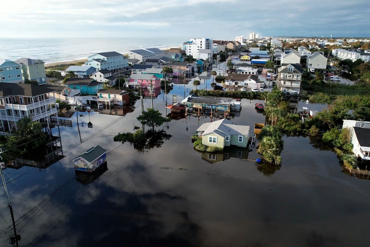 Flood waters rise through Pleasure Island’s Carolina Beach township after a  storm front delivered a mass amount of rain during a high tide event.