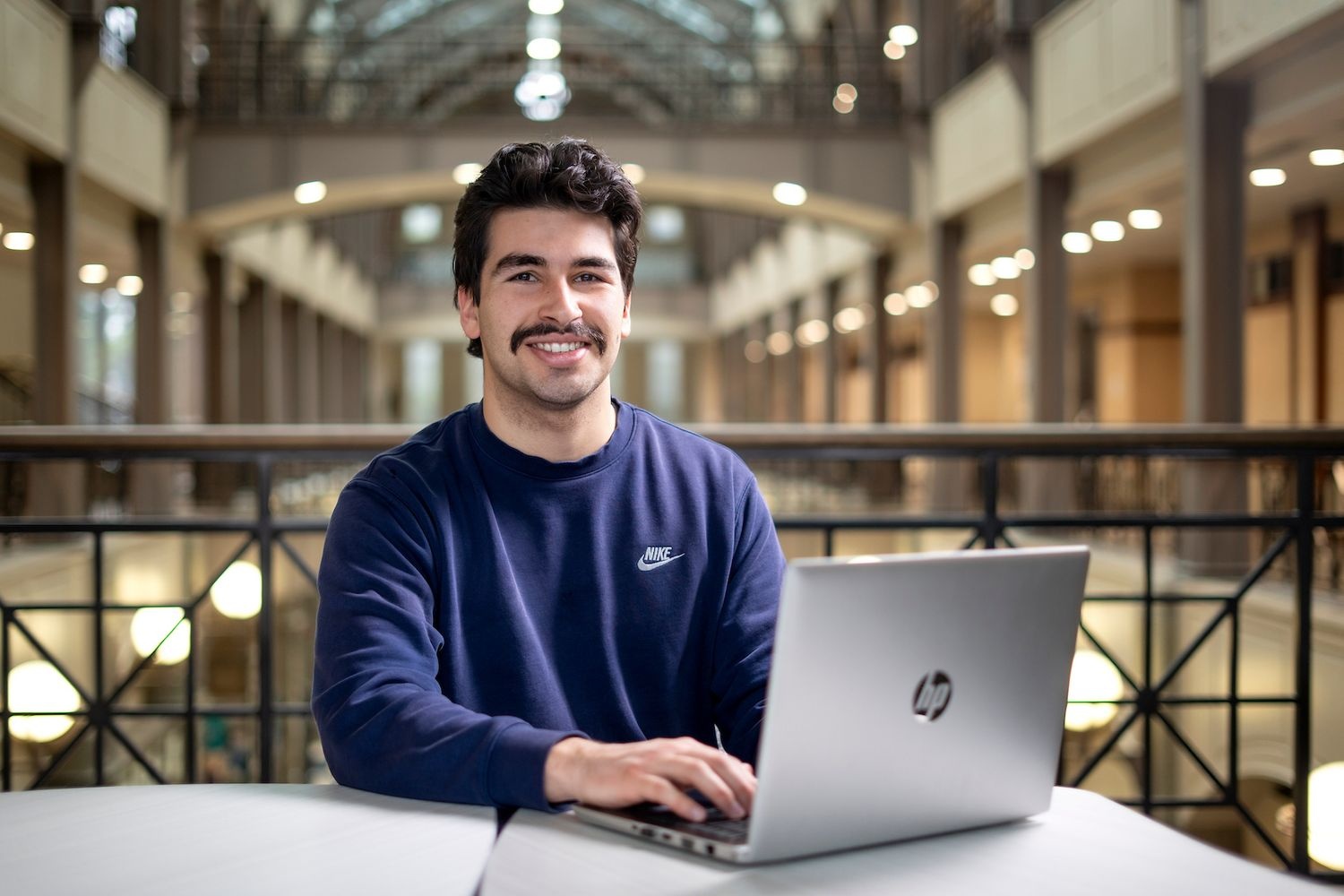 Student posing in building at UNCW