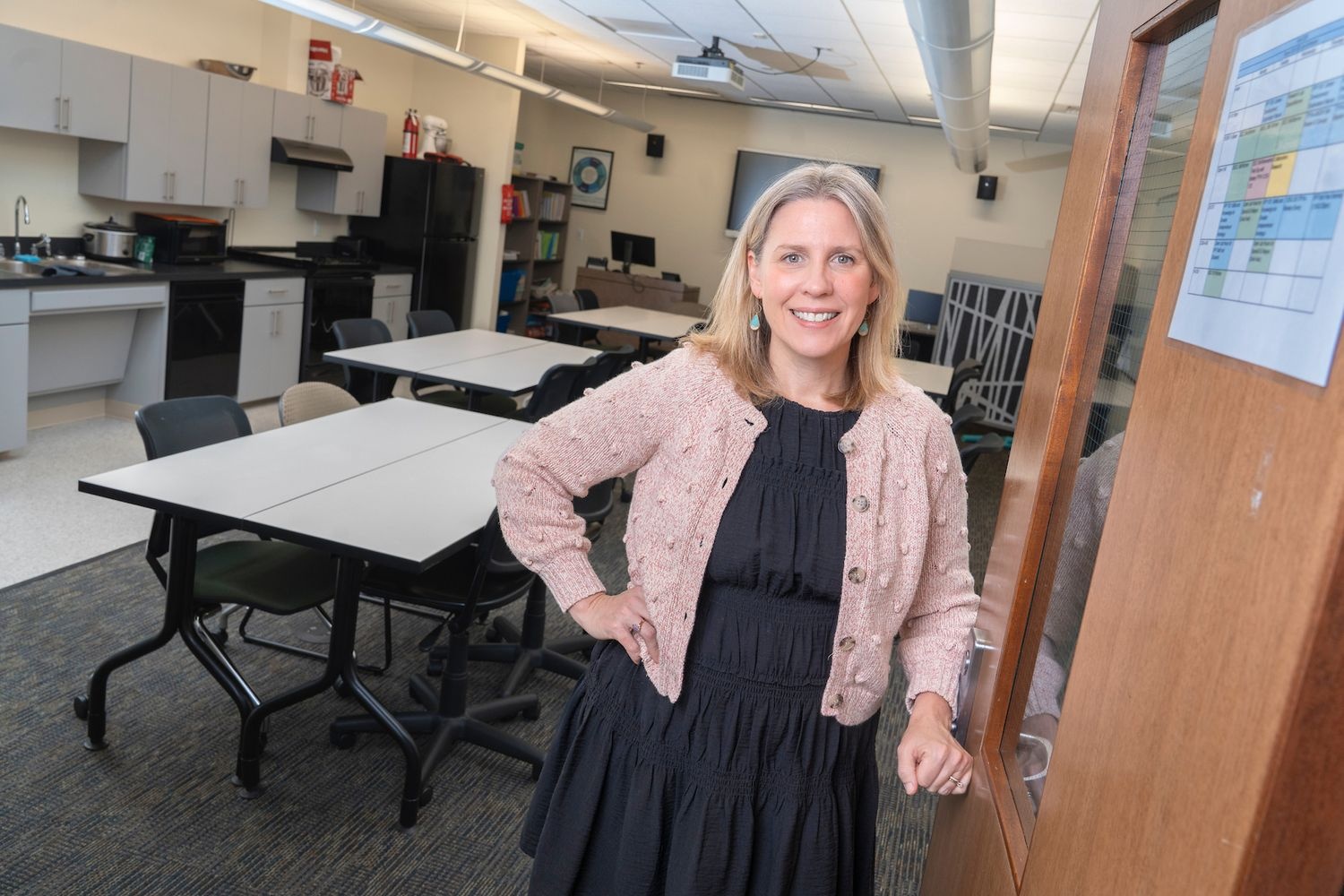 A woman stands in a classroom in the Sayed Education Building on the UNCW campus 