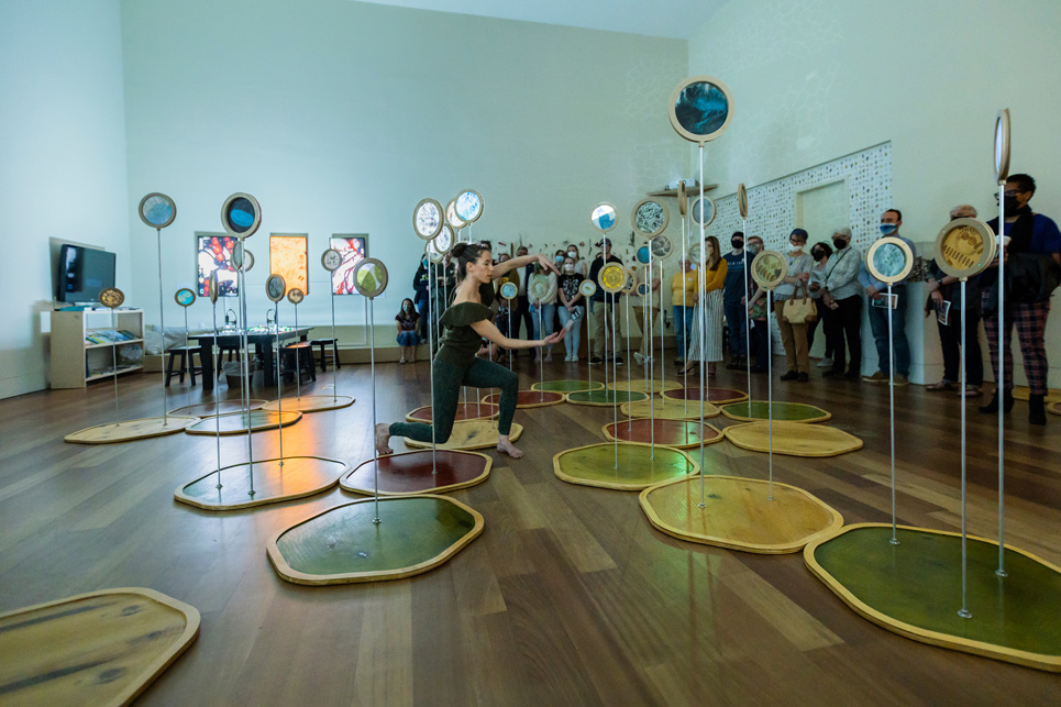 Assistant Professor gives a guided tour of the "Confluence" exhibit for UNCW Faculty and Staff